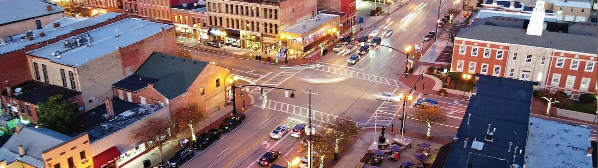 An aerial photo, taken at dusk, of a bustling intersection in downtown Delaware, Ohio.